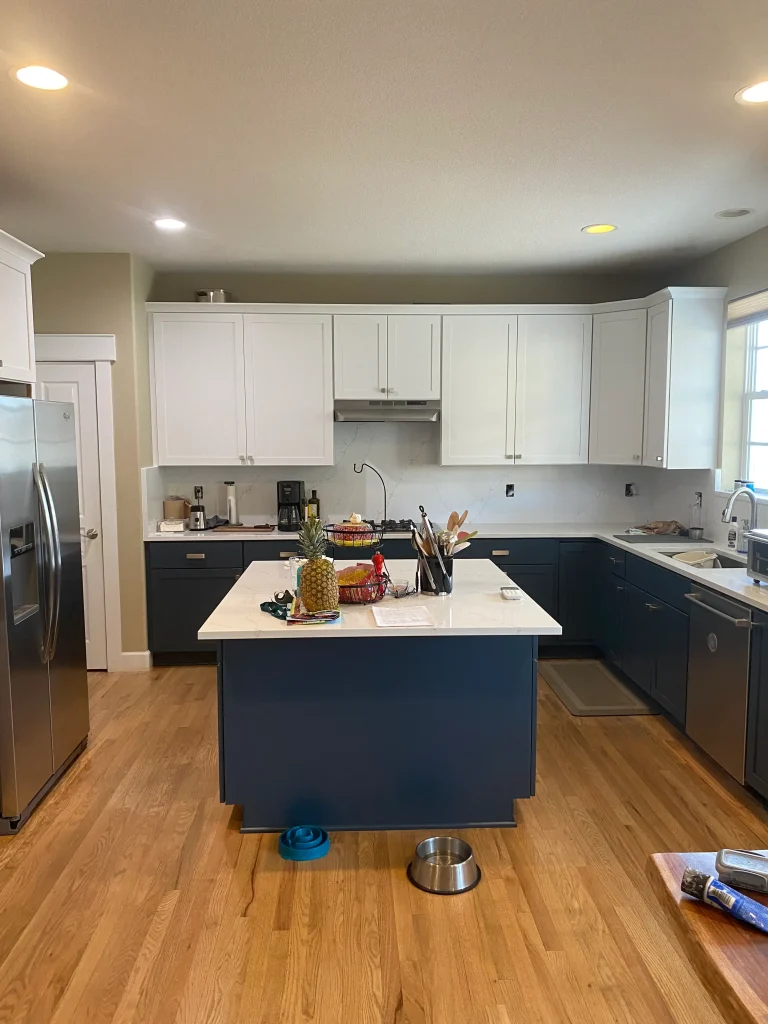After cabinet refacing in Denver kitchen with white upper cabinets and navy blue lower cabinets