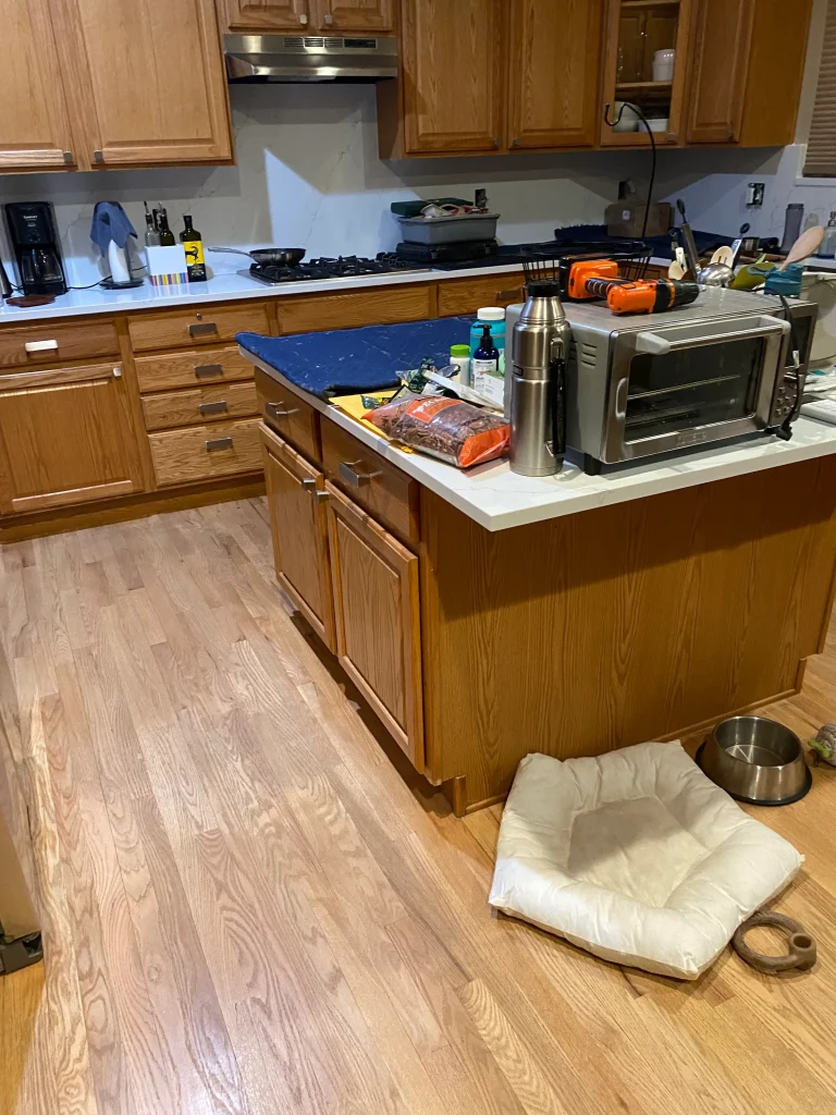 Before cabinet refacing in Denver kitchen with honey oak cabinets, white countertops, and center island