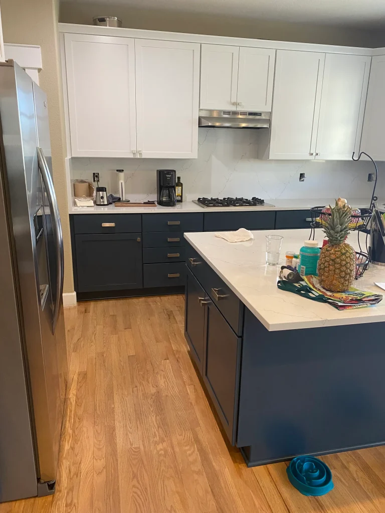 Modern Denver kitchen after cabinet refacing with two-tone cabinets and quartz countertops